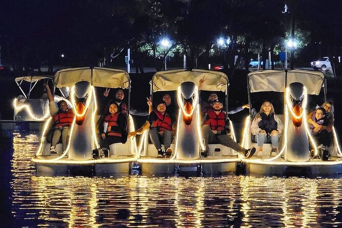 Illuminated Swan Boat Night Ride on Rainbow Lagoon in Long Beach - A glowing boat ride, not a harbor cruise